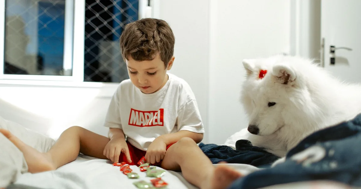A dog lying calmly on a mat working through a frozen food puzzle at home